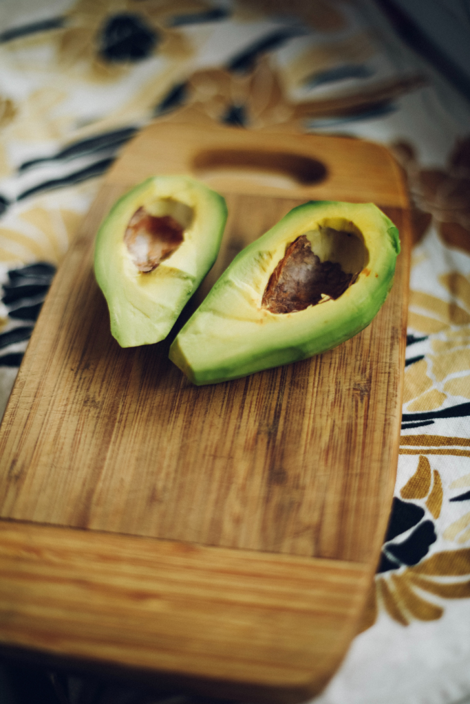 Advocado halves ready to grill on the BBQ