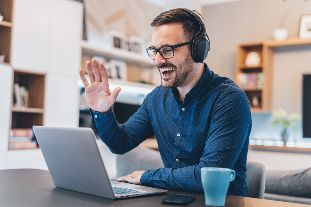 Man on video call, What they do miss however is the social interactions and this is why it's important for employees to recognise the need to hold regular team meetings over the phone or by video conference and not just rely on messages and emails to communicate.