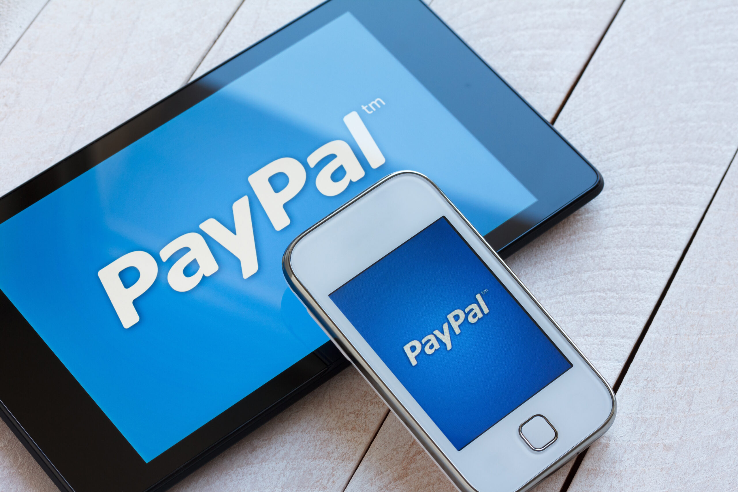 PayPal payment system logo on tablet and smartphone - Mobile, Internet